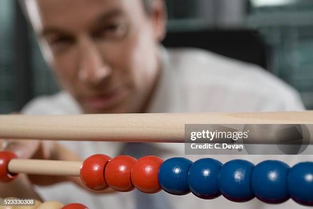 businessman using abacus - abaco fotografías e imágenes de stock