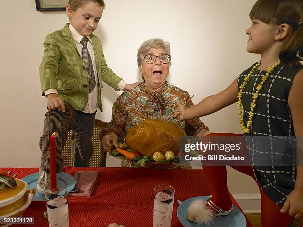 grandmother and two obnoxious kids - thanksgiving indulgence stock pictures, royalty-free photos & images