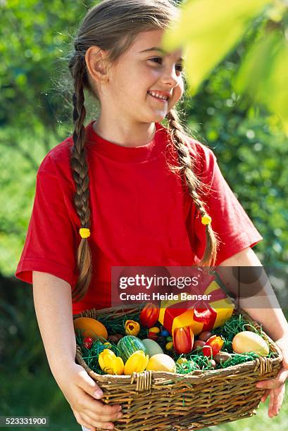 little girl holding easter basket - easter basket with candy stock pictures, royalty-free photos & images