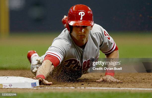 David Lough of the Philadelphia Phillies dives back into first base in the second inning against the Milwaukee Brewers at Miller Park on April 22,...