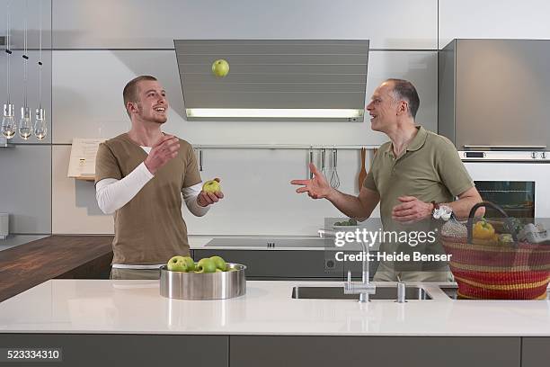 father and son playing in kitchen - man catching stock pictures, royalty-free photos & images