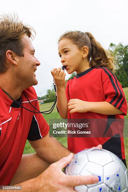 girl blowing soccer coach's whistle - coach whistle stock pictures, royalty-free photos & images