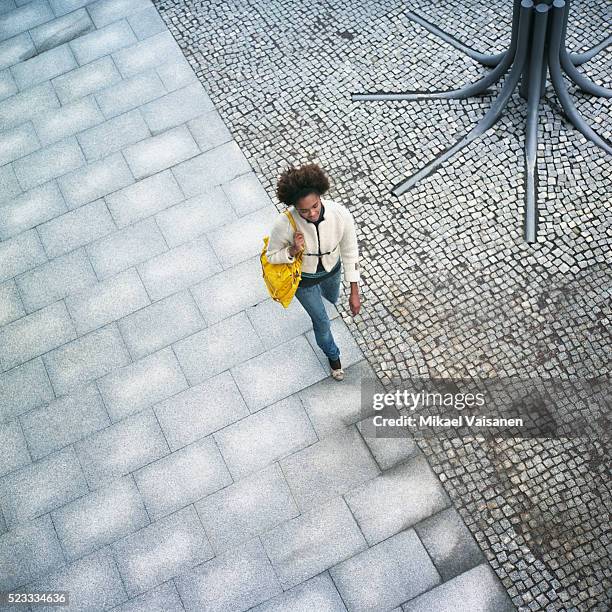 young woman walking outdoors - sidewalk stock pictures, royalty-free photos & images