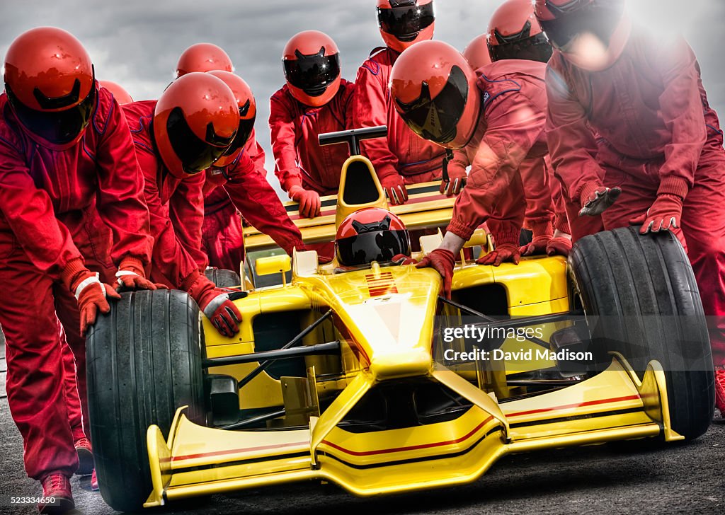 Pit Crew Team Pushing open-wheel single-seater racing car Racecar