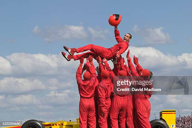 happy race team lifting racecar driver - pit stop stock pictures, royalty-free photos & images