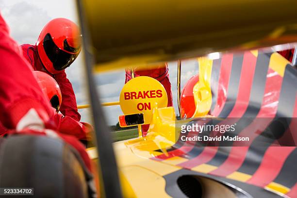 sign telling racecar driver brakes on during pit stop - pitstop stock pictures, royalty-free photos & images