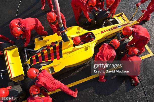 open-wheel single-seater racing car racecar in pit box during pit stop - pitstop team stock pictures, royalty-free photos & images