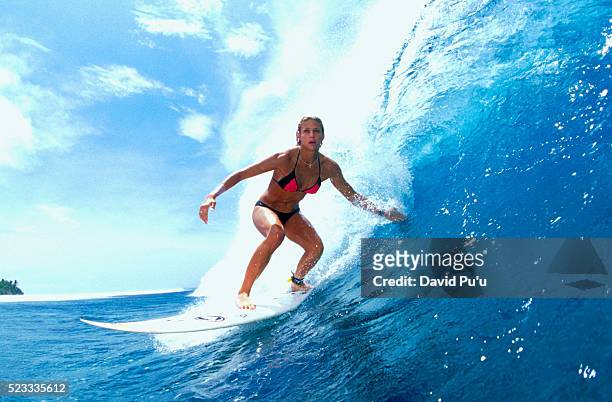 woman surfing a wave - woman surfing stock pictures, royalty-free photos & images