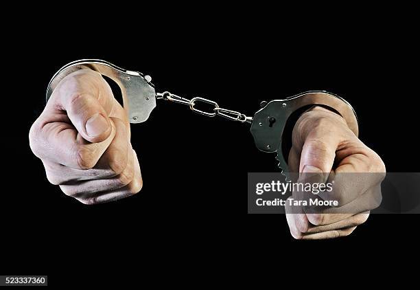 hands in handcuffs - handcuffs bildbanksfoton och bilder