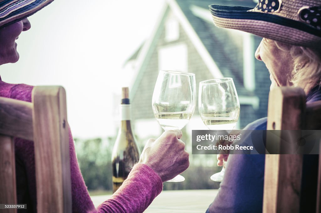 Two women enjoying a glass of wine outdoors in Nantucket, MA