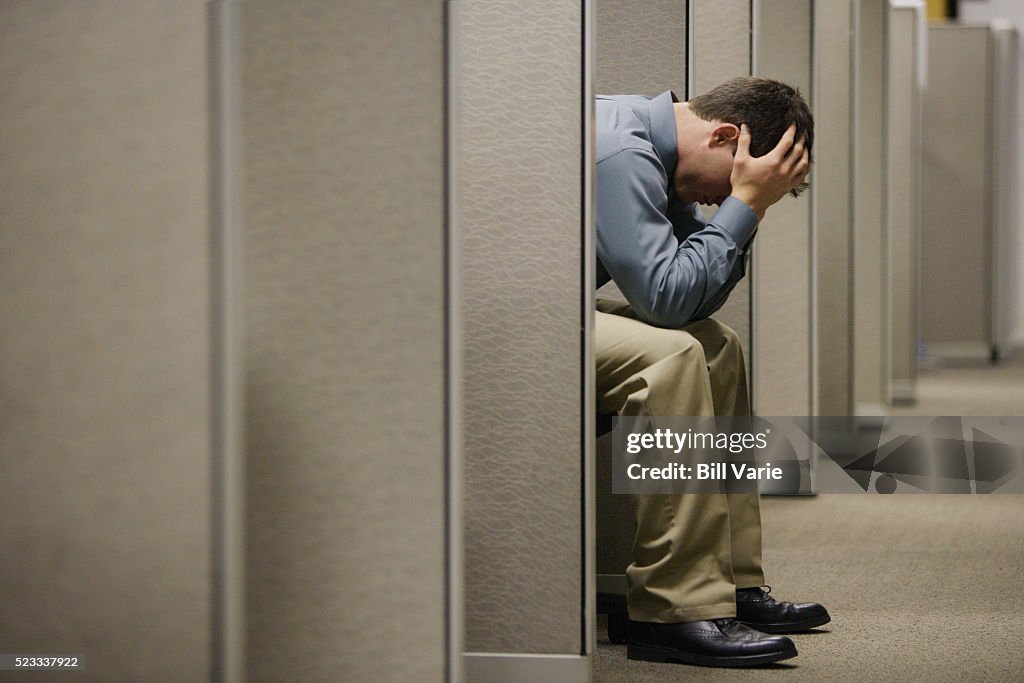 Tired Office Worker in Cubicle