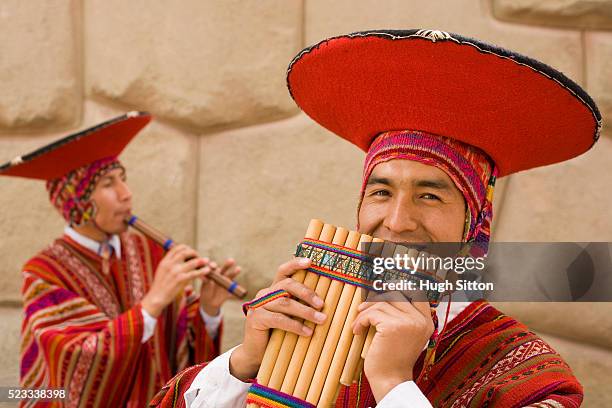 two pipers in traditional peruvian dresses - guaira fotografías e imágenes de stock