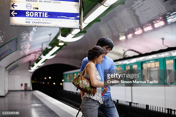 couple in subway station - looking at subway map stock pictures, royalty-free photos & images