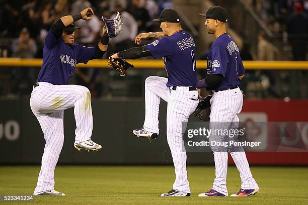 Gerardo Parra, Brandon Barnes and Carlos Gonzalez of the Colorado Rockies celebrate their victory over the Los Angeles Dodgers at Coors Field on...