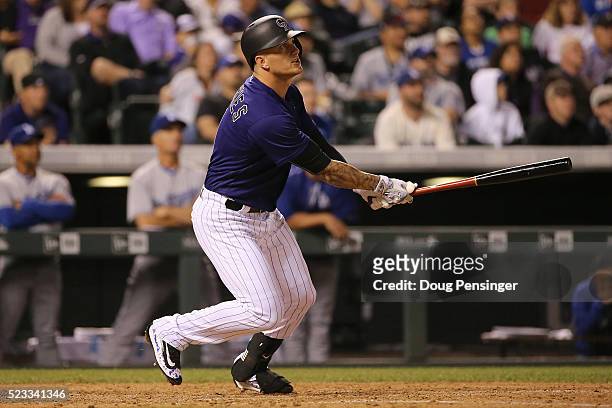 Brandon Barnes of the Colorado Rockies watches his game winning two RBI triple off of Chris Hatcher of the Los Angeles Dodgers to take a 7-5 lead in...