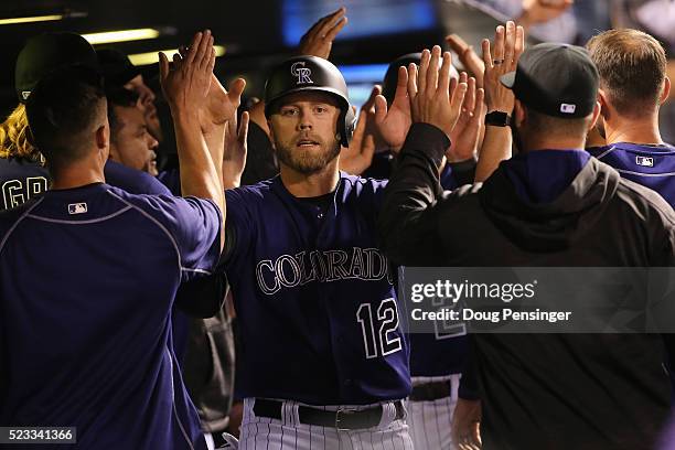 Mark Reynolds and Nolan Arenado of the Colorado Rockies celebrate after scoring on the game winning triple by Brandon Barnes off of Chris Hatcher of...