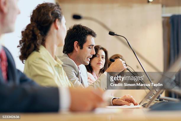 businessman speaking at conference - microphone debate stock pictures, royalty-free photos & images