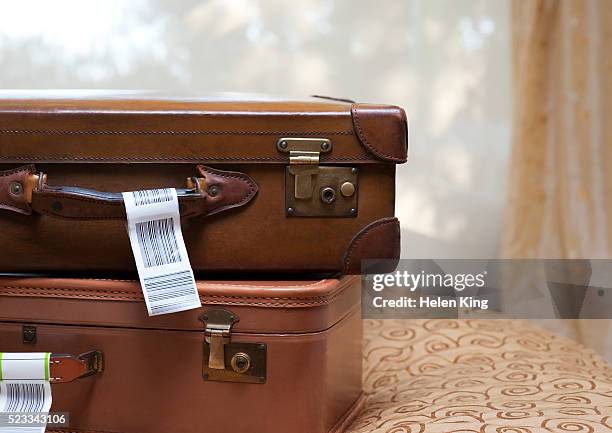 suitcases on a bed - vintage luggage stock pictures, royalty-free photos & images