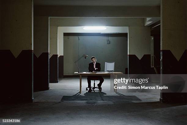 businessman in a dark room - gangster stock pictures, royalty-free photos & images