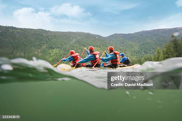 group of men whitewater rafting - inflatable raft fotografías e imágenes de stock