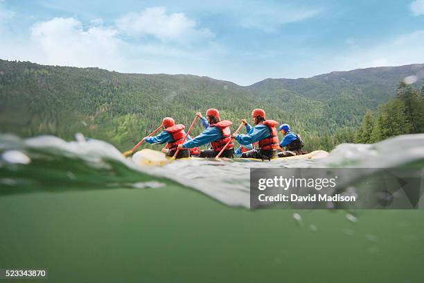 group of men whitewater rafting - rafting sulle rapide foto e immagini stock