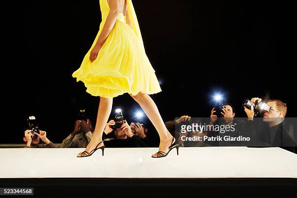 photographing model at fashion show - yellow dress stock pictures, royalty-free photos & images