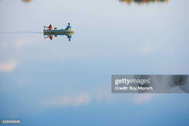 fishermen in motorboat - recreational boat stock pictures, royalty-free photos & images