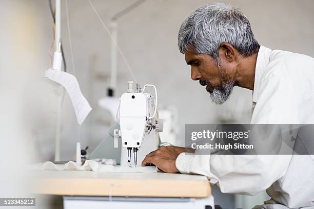 man sewing - hugh sitton india fotografías e imágenes de stock