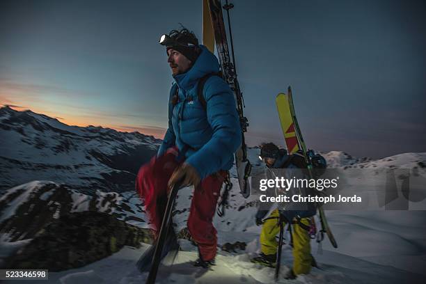 ski tourer hiking up in the mountains at night - night skiing stock pictures, royalty-free photos & images