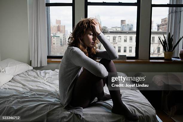 lonely woman in bedroom - depressed bildbanksfoton och bilder