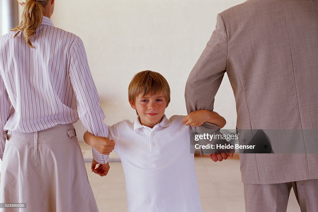 Boy between parents