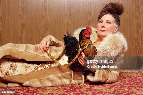 woman with chicken - winterjacke stock-fotos und bilder