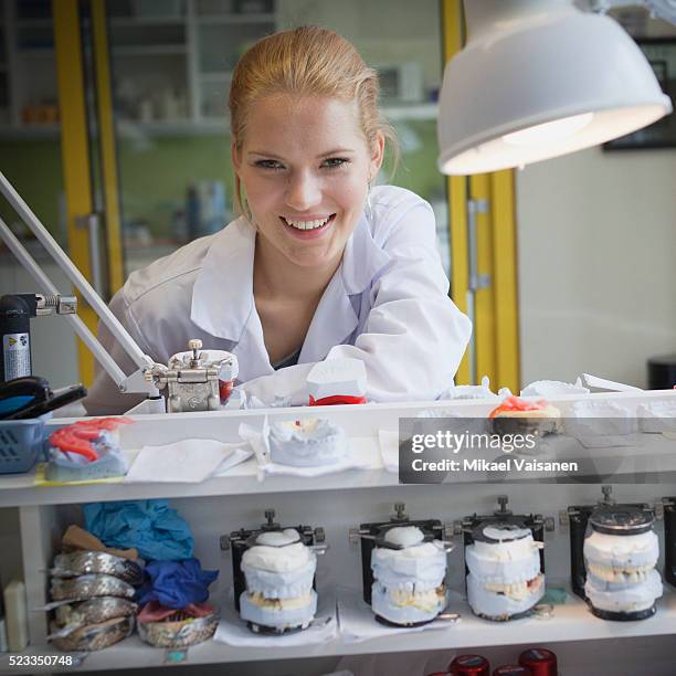 young woman working in a dental laboratory - dental mould stock pictures, royalty-free photos & images