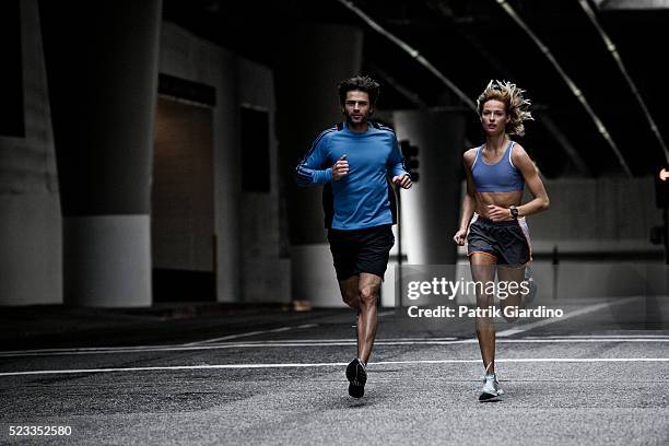 young couple running in the city - street running bildbanksfoton och bilder