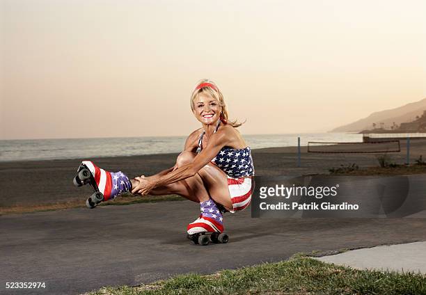 woman in red, white and blue outfit roller skating - american flag ocean stock pictures, royalty-free photos & images