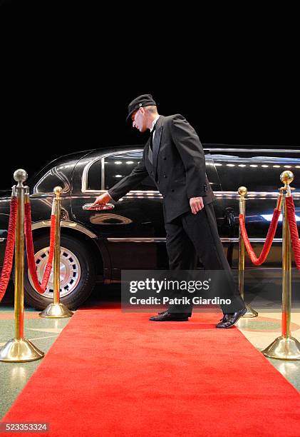 driver opening limo door at red carpet event - red carpet limo stock pictures, royalty-free photos & images