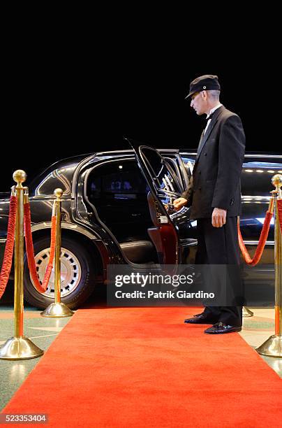 driver holding limo door open - limousine photos et images de collection