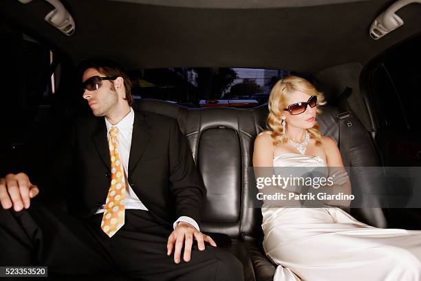 bored celebrity couple in limo - glamour couple stock pictures, royalty-free photos & images