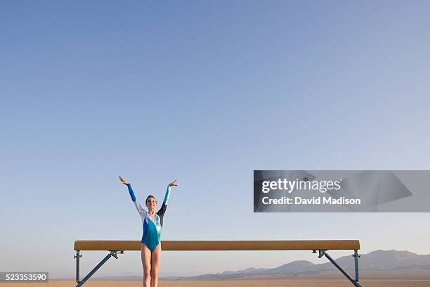 girl performing on balancing beam in the desert - 平均台 ストックフォトと画像