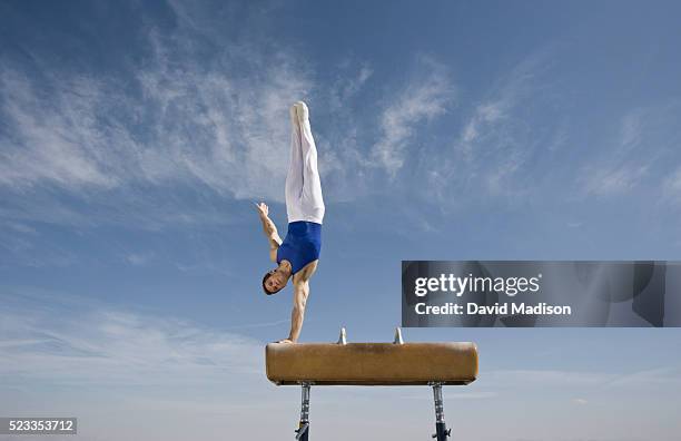 gymnast performing on pommel horse in the desert - pommel horse bildbanksfoton och bilder