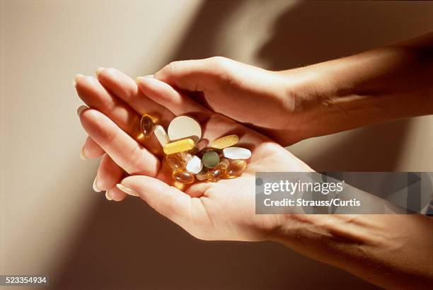 handful of vitamins - vitamin d stock pictures, royalty-free photos & images