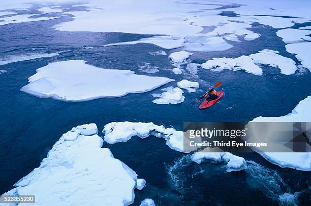 kayak navigating an ice floe - winter footpath stock pictures, royalty-free photos & images