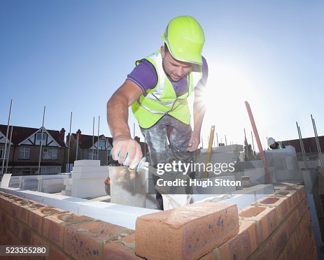 Bricklayer working on construction site Bricklayer working on construction site
