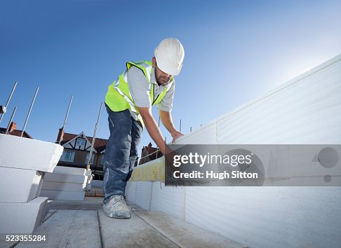 Bricklayer working on construction site Bricklayer working on construction site