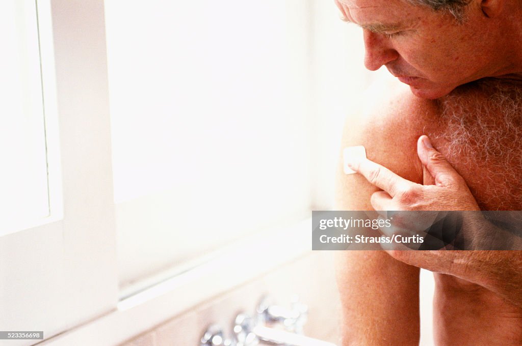 Man Applying Nicotine Patch