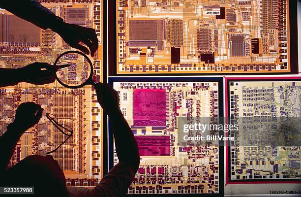 engineers working over light table - computer part stock pictures, royalty-free photos & images