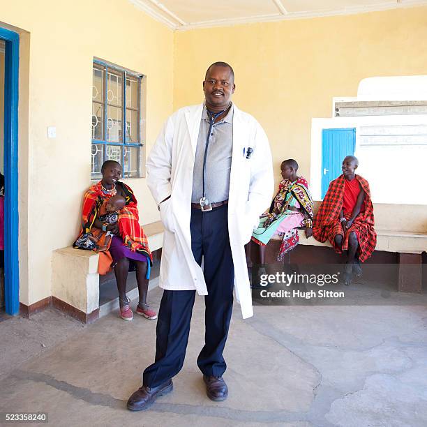 doctor in waiting room of village hospital - kenya business stock pictures, royalty-free photos & images