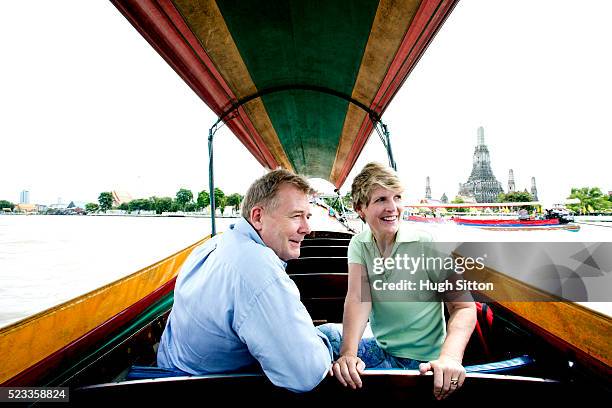 mature couple in tourboat sightseeing, bangkok, thailand - tour boat stock pictures, royalty-free photos & images