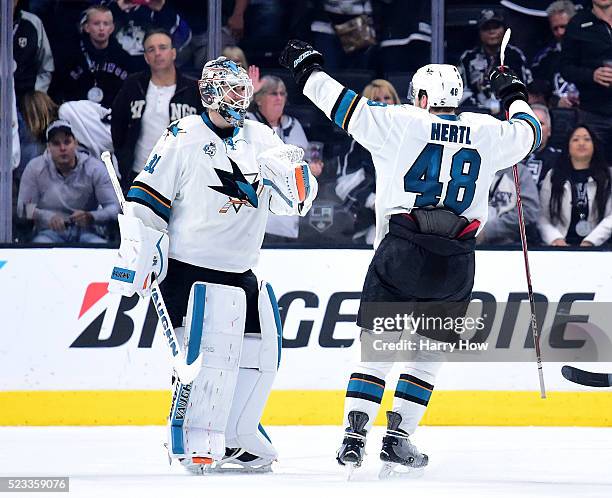 Martin Jones of the San Jose Sharks and Tomas Hertl celebrate a 5-3 win over the Los Angeles Kings to clinch the series during Game Five of the...