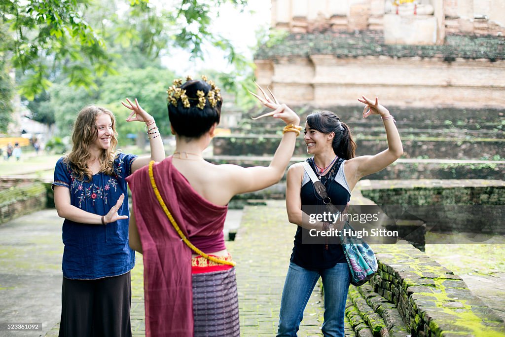 Two young women imitating traditional Thai dance, Chiang Mai, Thailand